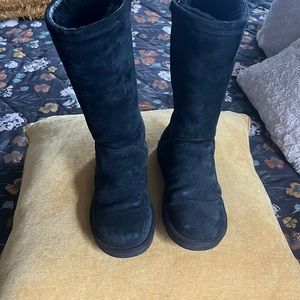 Zip up Ugg boots. No rips or tears. Some creasing and scuffs